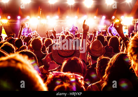 Crowd enjoying a rock band's performance at a music festival Stock Photo