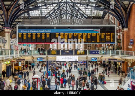 Liverpool Street Station Concourse showing commuters looking at the arrivals/departure board for train times, London England UK Stock Photo