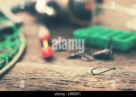 fishing hook and other equipment on old table Stock Photo