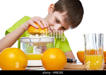 Happy boy with oranges and juicer isolated white Stock Photo