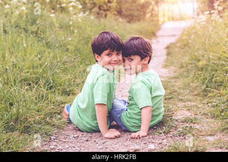 Brothers sitting on the grass