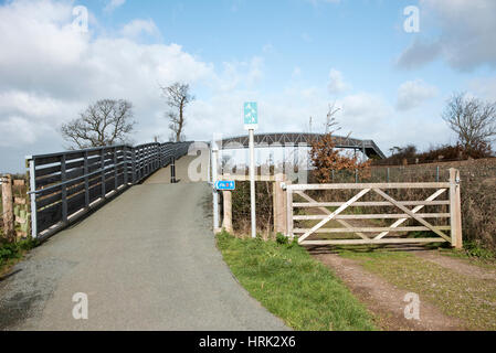 Cycleway and pedestrian footpath across rail lines to the Exe Estuary footpath near Starcross in South Devon England UK Stock Photo
