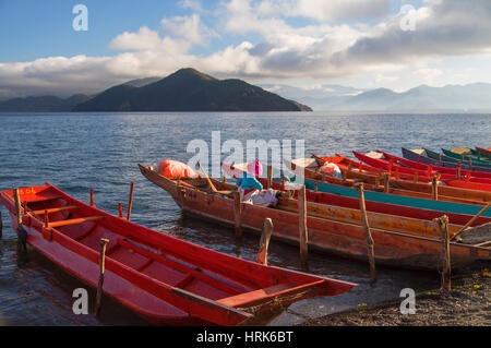 Mosu woman on boat, Luoshui, Lugu Lake, Yunnan, China Stock Photo