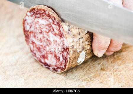 Slicing salami Stock Photo