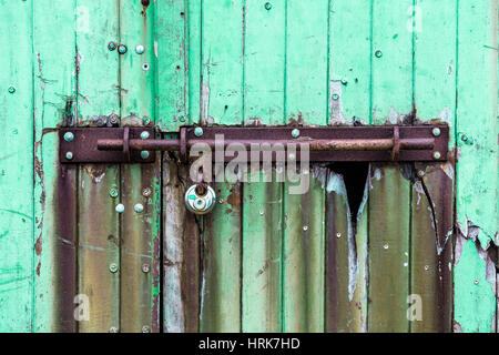 Long rusty metal bolt lock on boathouse door, Valentia Island, County Kerry, Ireland Stock Photo