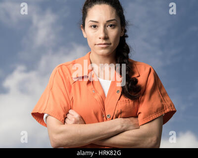 Woman wearing orange prison jumpsuit Stock Photo
