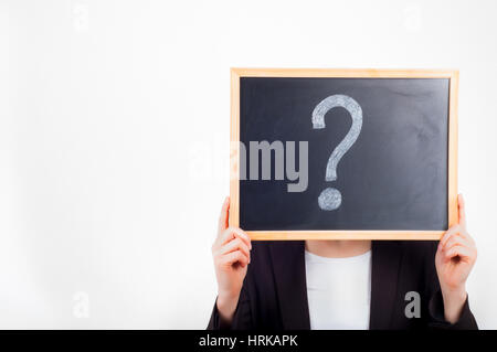 Woman holding chalkboard with question mark on it before face. Stock Photo