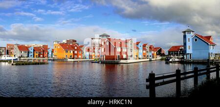 Colourful Scandinavian style wooden houses at Reitdiephaven. Modern housing development in the city of Groningen, Netherlands (stitched image) Stock Photo
