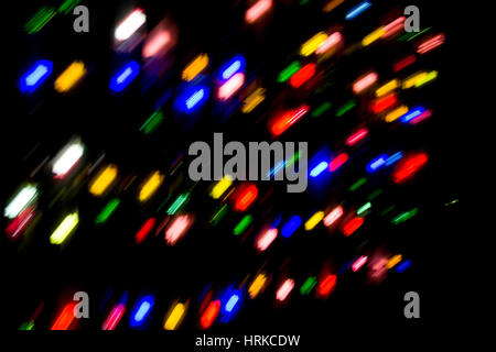 Red, orange, blue, yellow and green lights in the dark. Moement blur to create dynamism Stock Photo