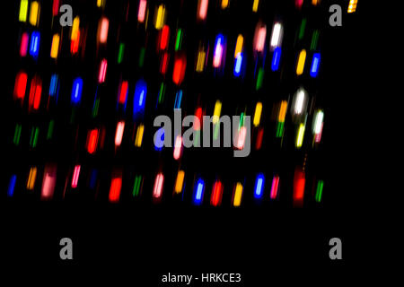Red, orange, blue, yellow and green lights in the dark. Moement blur to create dynamism Stock Photo