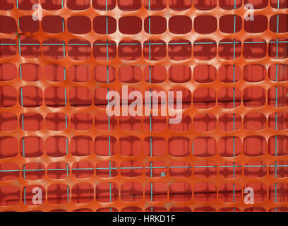 Plastic orange safety net to delimit the area of a road construction site in the city Stock Photo