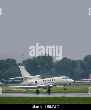 Kiev, Ukraine - June 5, 2012: Dassault Falcon 50EX business jet is landing in bad weather conditions under heavy rain Stock Photo