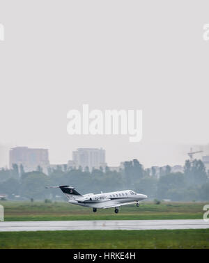 Kiev, Ukraine - June 5, 2012: Cessna 525A CitationJet 2 Plus business jet is taking off in bad weather conditions under heavy rain Stock Photo