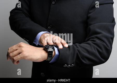 businessman looking the watch on his wrist, luxury men wristwatch Stock Photo