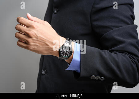 closeup black watch on wrist of businessman, luxury men wristwatch Stock Photo