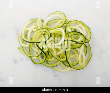 Zucchini noodles displayed on white Stock Photo