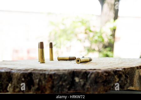 The bullets on the wooden background. Bullets for pneumatic. Stock Photo