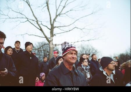 Trump supporters listen to the National Anthem during the Make American Great Again rally at the Lincoln Memorial   Scenes from Washington D.C. during Make America Great Again rally at the Lincoln Memorial on the eve of Donald J. Trump's inauguration as the 45th President of the United States of America. Stock Photo