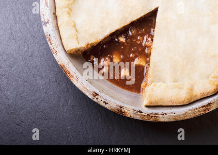 Freshly baked apple pie on dark stone background Stock Photo