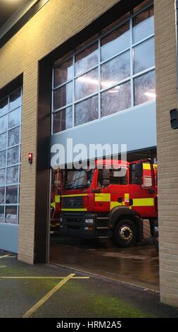 Fire engine inside a fire station with the door half open, Cheltenham, UK Stock Photo