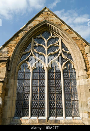 Stained glass window and Gothic stone tracery, St Thomas of Canterbury Church, Frisby on the Wreake, Leicestershire, England, UK Stock Photo