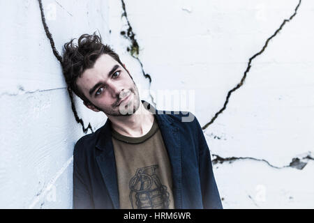 Portrait of a slightly disheveled young man looking directly at camera. Stock Photo