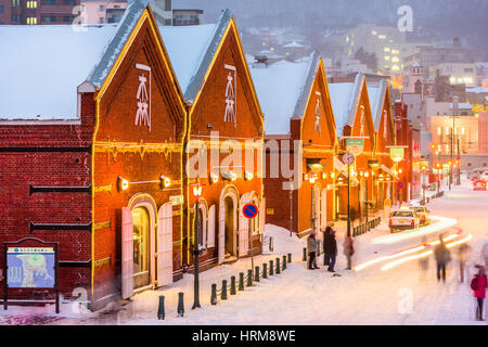 HAKODATE, JAPAN - FEBRUARY 2, 2017: Tourists enjoy a snowy evening at historic Kanemori warehouse district. Hakodate Port was among the first Japanese Stock Photo