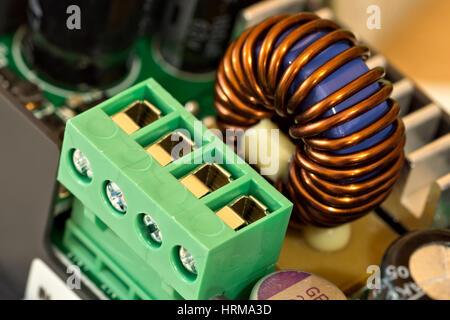 Wire connector and inductance coil on circuit board Stock Photo