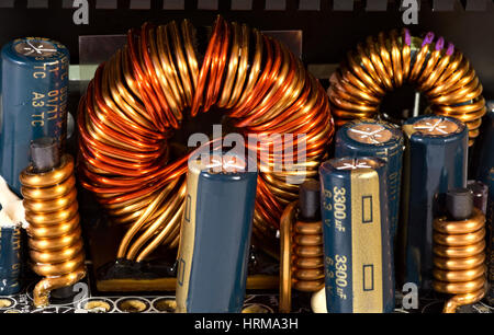 Inductance coil and capacitors in power supply unit Stock Photo