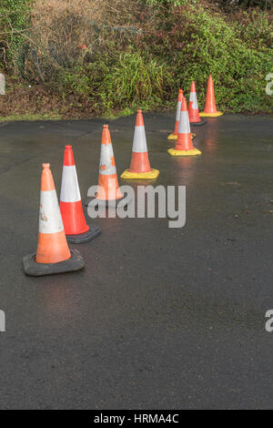 Line of road cones separating off an area from pedestrian access. Stock Photo