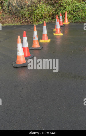 Line of road cones separating off an area from pedestrian access. Stock Photo