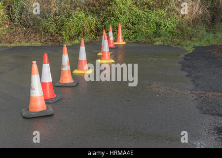 Line of road cones separating off an area from pedestrian access. Stock Photo