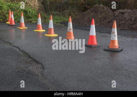 Line of road cones separating off an area from pedestrian access. Stock Photo