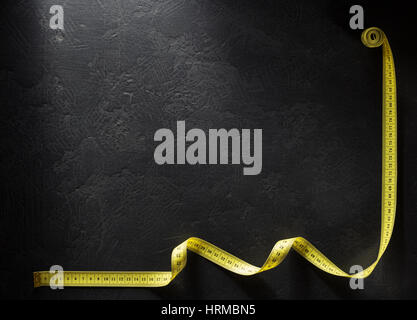 tailor measuring tape on black background Stock Photo