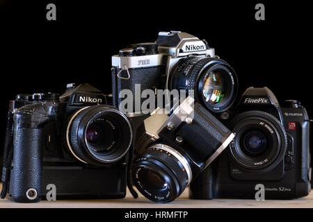 Pile of old retro film cameras - Nikon, Olympus Stock Photo