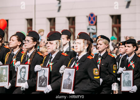 The Marching Formation Of Cadet Girls From Gomel State Cadet School With Portraits Of WW2 Heroes In Ceremonial Parade Procession. Celebration Of Victo Stock Photo