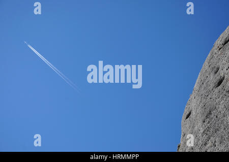 Airplane trace on blue sky Stock Photo