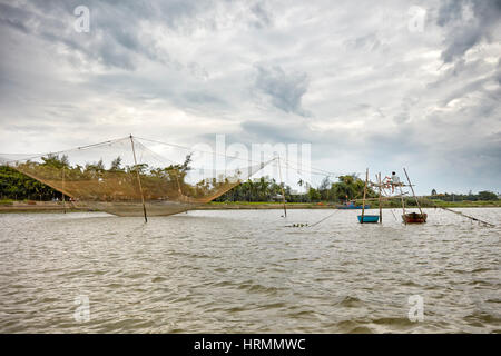 Stationary lift fishing net on the Thu Bon River. Hoi An, Quang Nam Province, Vietnam. Stock Photo