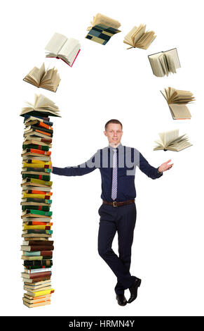 Young student telling about education process and stands in free pose beside pile of books, isolated on white background. Stock Photo