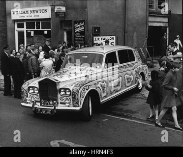 May 05, 1967 - John Lennon's decorated Rolls Royce: Beatle John lennon yesterday took delivery of his re-decorated Rolls Yesterday. It has been painted yellow, with signs of the zodiac and bunches of flowers in red, green and blue on the roof and the doors. The wheels are in red, white, blue and orange. Photo shows John Lennon's decorated Rolls Royce, pictured in Chertsey, Surrey, yesterday. (Credit Image: © Keystone Press Agency/Keystone USA via ZUMAPRESS.com) Stock Photo