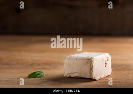 Cube of yeast on wooden background with copy space Stock Photo