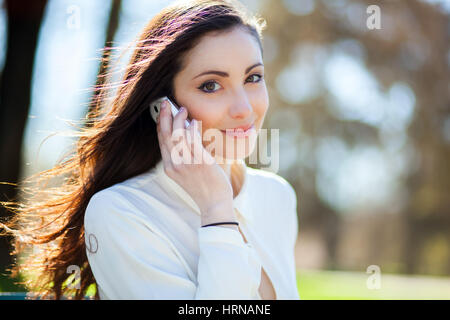 Portrait of an attractive woman talking on the phone Stock Photo