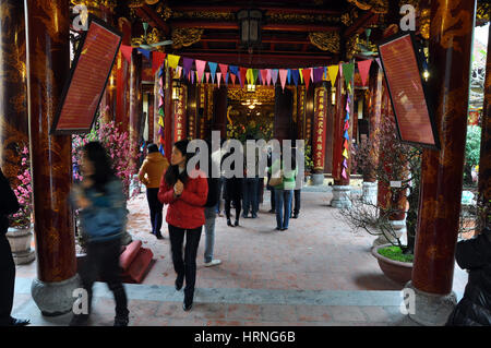 HANOI, VIETNAM - FEBRUARY 19, 2013: Buddhist worshippers praying in the interior of Bac Ma temple in Hanoi Vietnam Stock Photo