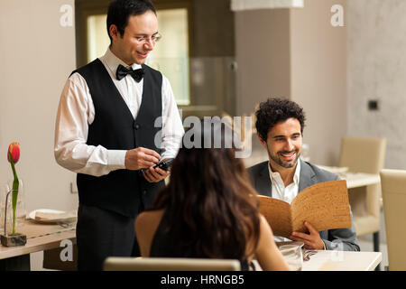 couple ordering dinner in a luxury restaurant hrngb5