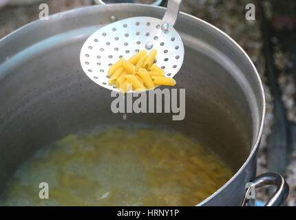 pasta cooked in boiling water in large pot of Italian restaurant in Rome City Stock Photo