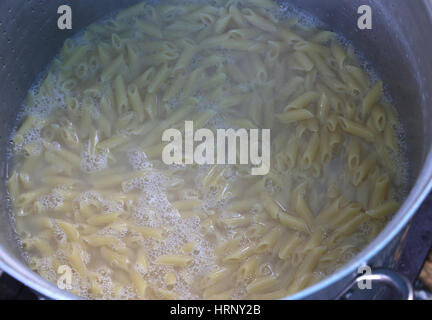 pasta called MEZZE PENNE in Italy cooked in the very hot water in large pot of Italian restaurant Stock Photo