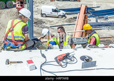 Zrenjanin, Vojvodina, Serbia - June 29, 2015: High elevated cherry picker with people is working at new assembled canopies on construction site. Stock Photo