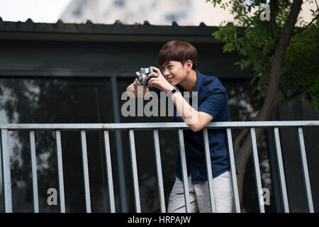 Young man taking photos Stock Photo