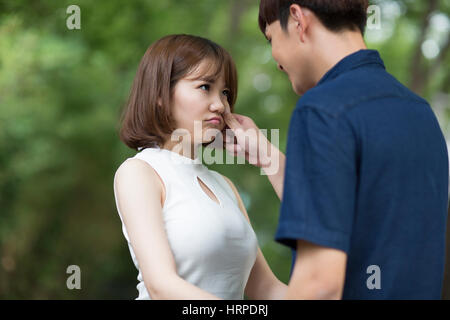 Young man comforting girlfriend Stock Photo