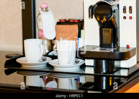 two white cups and cofee machine on table Stock Photo